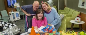 family together at hospital while their daughter receives treatment